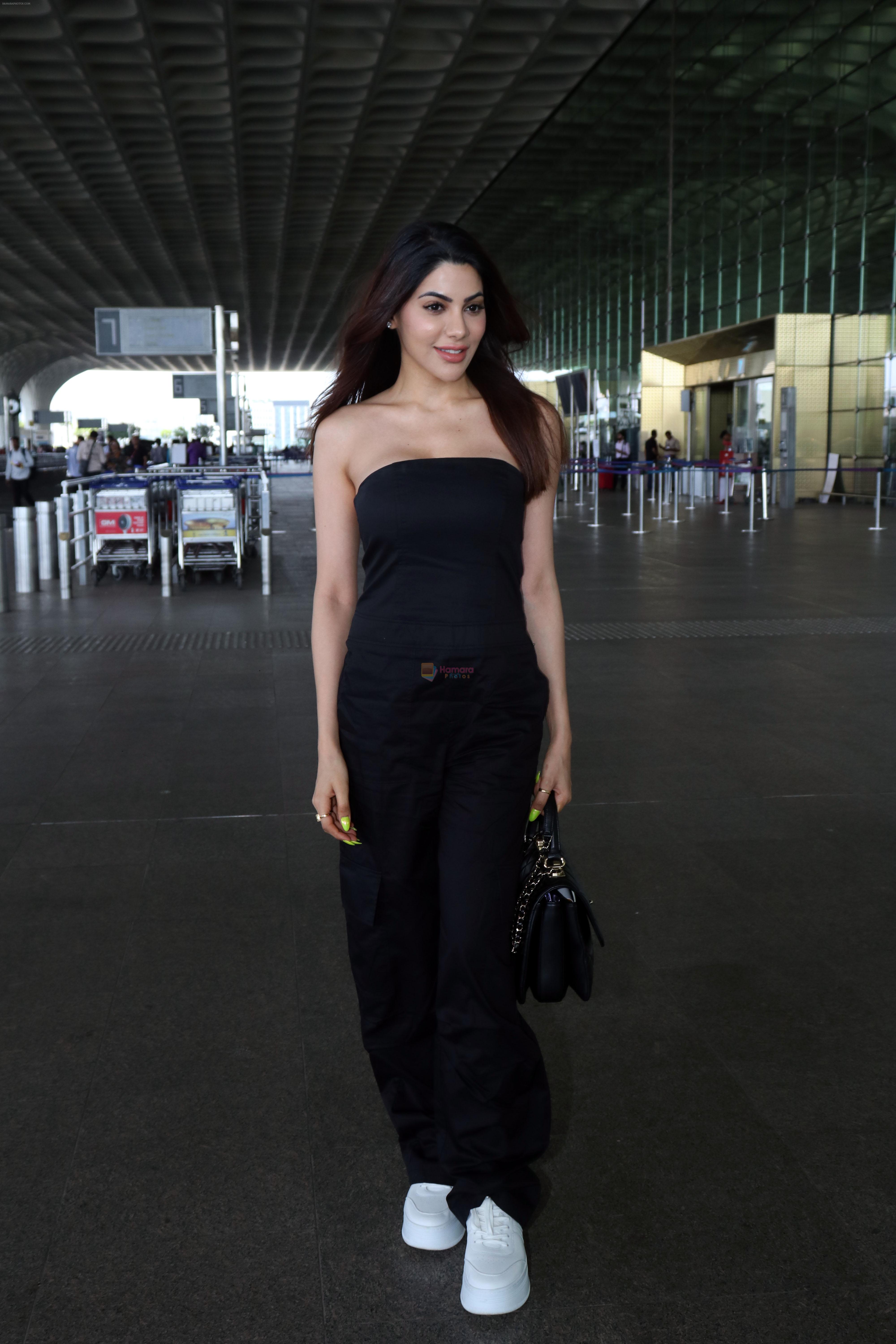 Nikki Tamboli wearing all black strapless bodycon dress, white sneakers